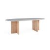 A luxurious dining table by Jonathan Adler with a white Carrara marble top and T-shaped legs crafted from solid oak 