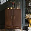 Elegant dark brown wood cabinet with ribbed brass handles and feet