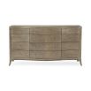 A sophisticated dresser by Caracole with contemporary curves and twelve spacious drawers