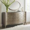 A sophisticated dresser by Caracole with contemporary curves and twelve spacious drawers