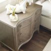 A charming and curvaceous bedside table by Caracole with an inlay pattern