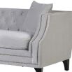 luxurious grey velvet sofa with silver studding and black legs