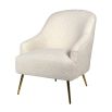 Faux sheepskin upholstered chair complemented by chic brass legs