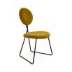 A rich yellow velvet dining chair with a blackened steel frame 