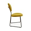 A rich yellow velvet dining chair with a blackened steel frame 