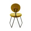 A rich yellow velvet dining chair with a blackened steel frame 