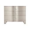 A luxurious chest of drawers with an undulating design, shagreen-embossed leather wrapping and nickel details  