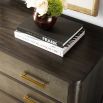 A luxurious chest with three textured drawers covered in embossed leather and finished with brushed brass handles