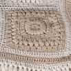 Beige and white crocheted throw blanket