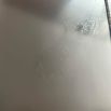 Sticker residue and slight scratching on side of chest
