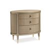 A glamourous bedside table with a curved design and champagne finish