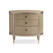 A glamourous bedside table with a curved design and champagne finish