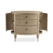 A glamourous bedside table with a curved design and champagne finish