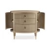 A glamourous bedside table with a curved design and champagne finish