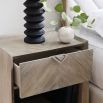 Striking modern bedside table with chevron patterning and triangular dark gold handle