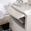 Elegant bedside table in matte pearl finish with tray pull-out, shelf and drawer