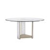 Glamorous round dining table with a glass top and divine crystal-like legs and brass accents