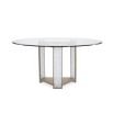 Glamorous round dining table with a glass top and divine crystal-like legs and brass accents
