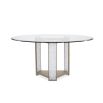 Glamorous round dining table with a glass top and divine crystal-like legs and brass accents