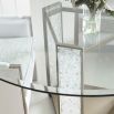 Glamorous round dining table with a glass top and divine crystal-like legs and brass accents
