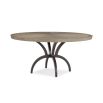 Striking round dining table with rustic bronze base and sunburst woodgrain surface