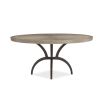 Striking round dining table with rustic bronze base and sunburst woodgrain surface