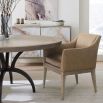 Striking round dining table with rustic bronze base and sunburst woodgrain surface