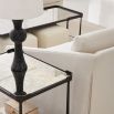 A gothic-inspired coffee table with an antique mirrored surface