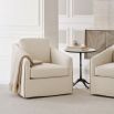 A luxury side table with a sophisticated stone top and opulent base