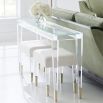 A contemporary console table crafted from clear acrylic with gold capped feet