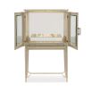 A luxury bar cabinet with leaf motif embellishments and a champagne finish