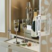 A luxury bar cabinet with leaf motif embellishments and a champagne finish