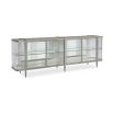 A contemporary console table by Caracole with clear, wave-effect acrylic doors and a mirrored interior