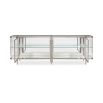 A contemporary console table by Caracole with clear, wave-effect acrylic doors and a mirrored interior