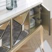 A dazzling sideboard by Caracole with mirrored glass doors and a glamorous gold finish