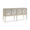 A dazzling sideboard by Caracole with mirrored glass doors and a glamorous gold finish