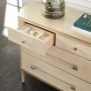 A sophisticated dresser by Caracole with a cream finish, acrylic handles and seven spacious drawers