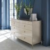 A sophisticated dresser by Caracole with a cream finish and nine soft-close drawers