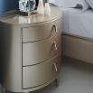 Decadent oval-shaped bedside table with pull handles and champagne finish