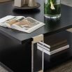 Bold square black coffee table with acrylic legs and brass accents 