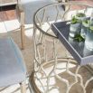 A luxury coral-inspired dining table with silver golden tones and a clear glass top 