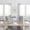 A luxury coral-inspired dining table with silver golden tones and a clear glass top 