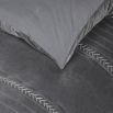 A luxurious grey velvet bedspread with handstitched details