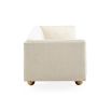 A stylish sofa by Jonathan Adler with a luxury cream upholstery and glamorous gold orb feet