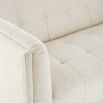 A stylish sofa by Jonathan Adler with a luxury cream upholstery and glamorous gold orb feet