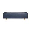 A luxurious modern sofa with navy leather upholstery and brass feet 