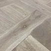 French-style dining table with parquet detailed surface and some imperfections