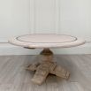 Elegant round dining table with washed wood finish