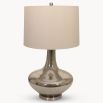 A luxurious side lamp with a crackle glaze finish and a natural linen shade