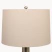 A luxurious side lamp with a crackle glaze finish and a natural linen shade